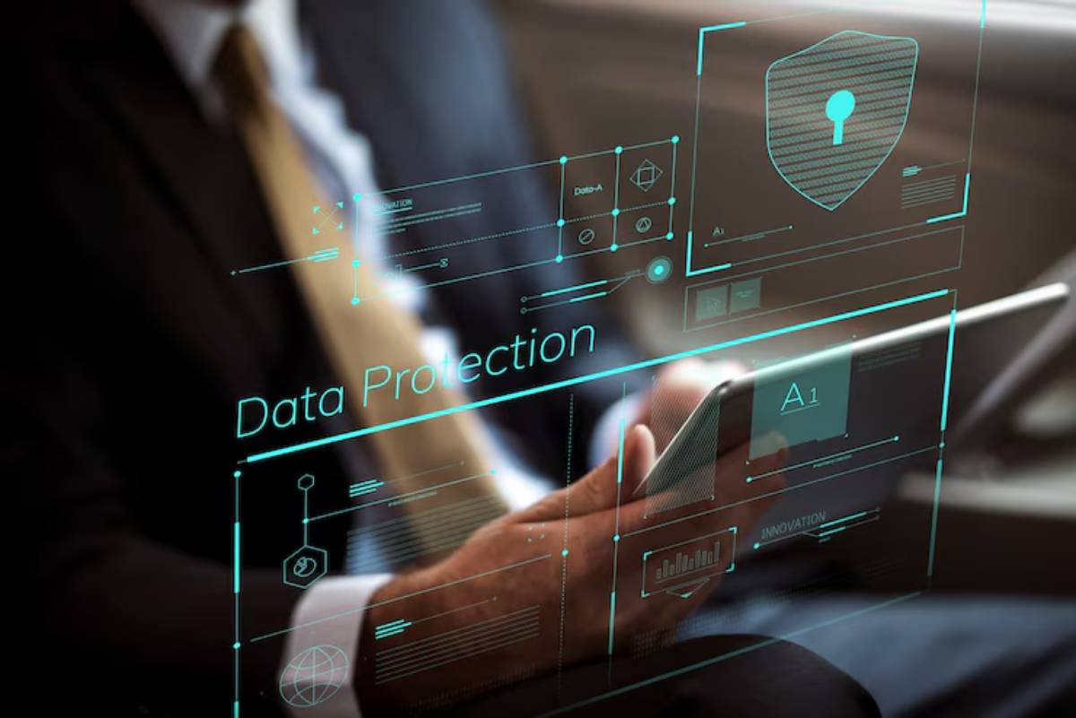 A businessman using a tablet, surrounded by floating digital data protection icons and information graphics.