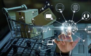 A shopping cart filled with packages and a hand interacting with digital icons representing online shopping and technology.
