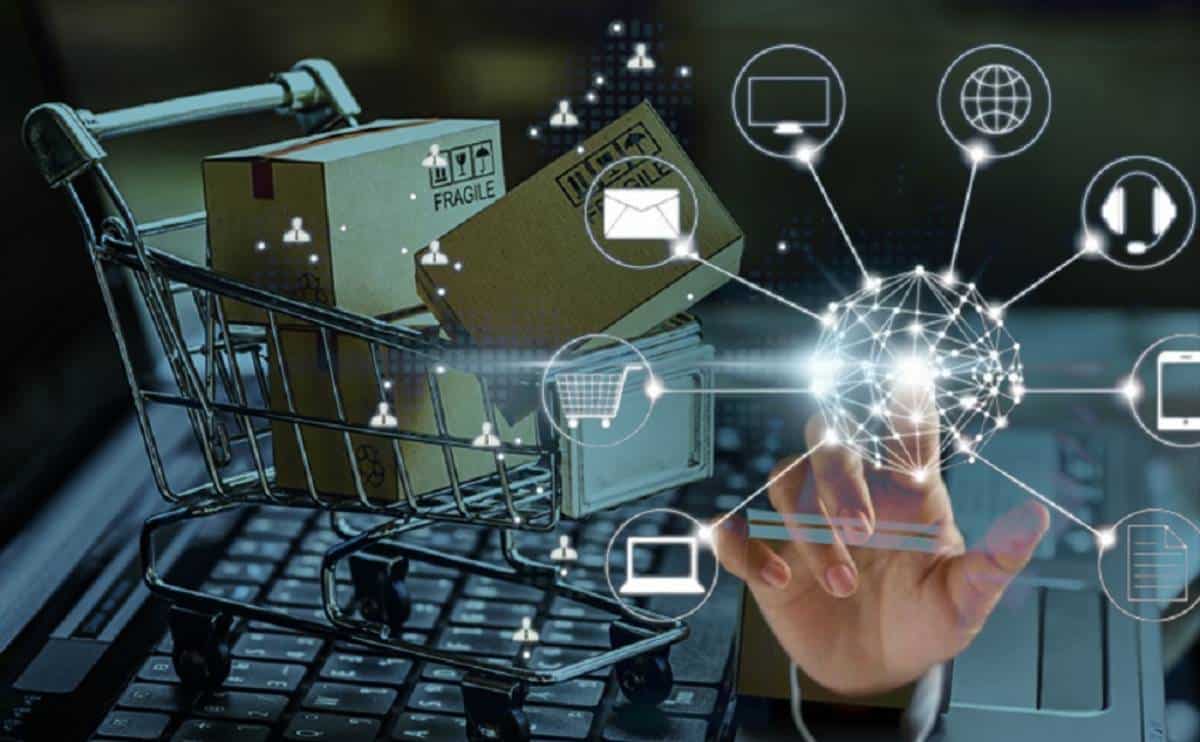 A shopping cart filled with packages and a hand interacting with digital icons representing online shopping and technology.