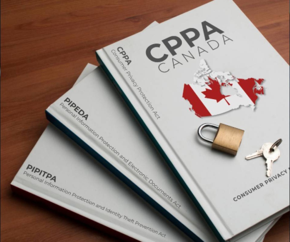Three Canadian privacy law books, titled CPPA, PIPEDA, and PIPITPA, with a padlock and keys on top, resting on a wooden surface.