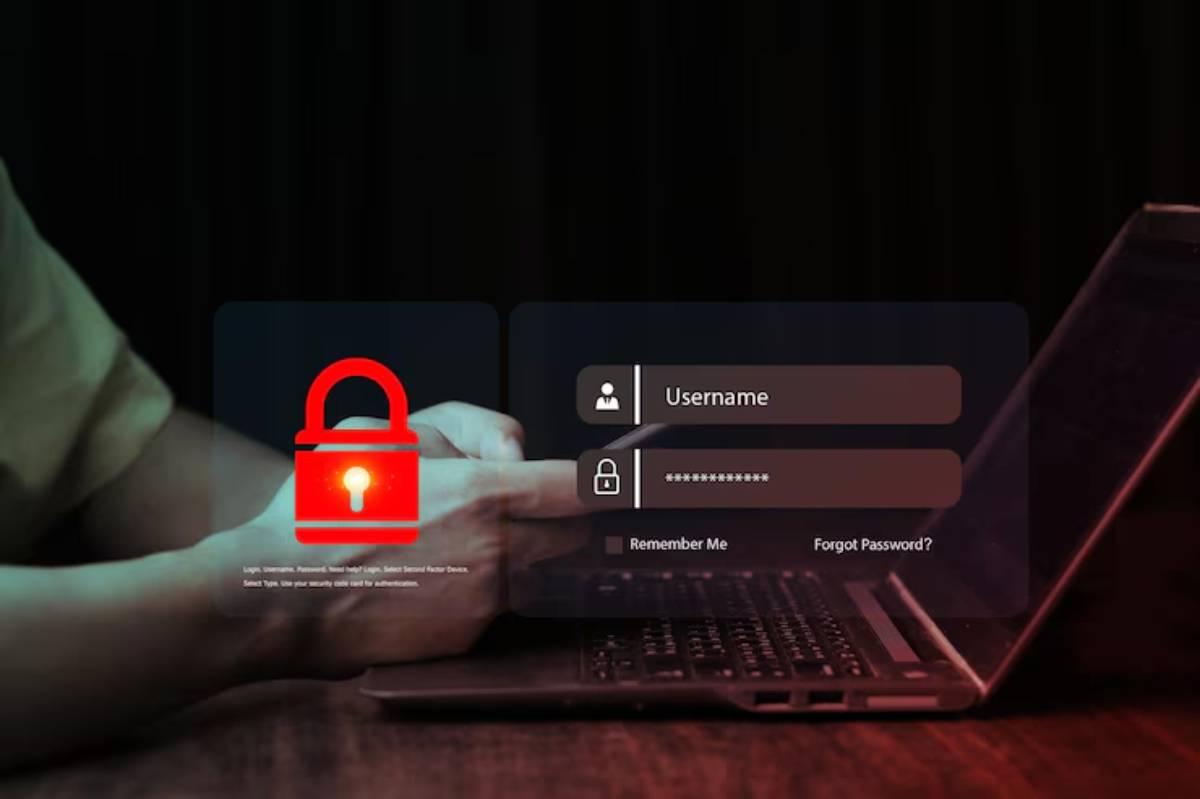 A person's hand enters login details on a laptop, featuring a red padlock symbol indicating security concerns.