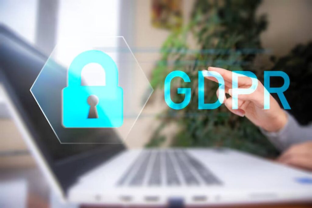 A person’s hands typing on a laptop, with a graphic overlay of a padlock and the letters GDPR symbolizing data protection.