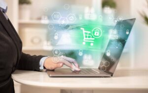 A business professional types on a laptop displaying digital shopping and security icons, symbolizing online commerce safety.