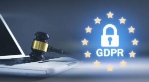 A person typing on a laptop with a prominent GDPR logo and a padlock graphic, symbolizing data protection and privacy.