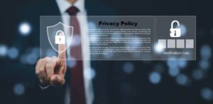 A business professional touches a holographic shield icon indicating privacy policy, with a padlock and verification code display nearby.