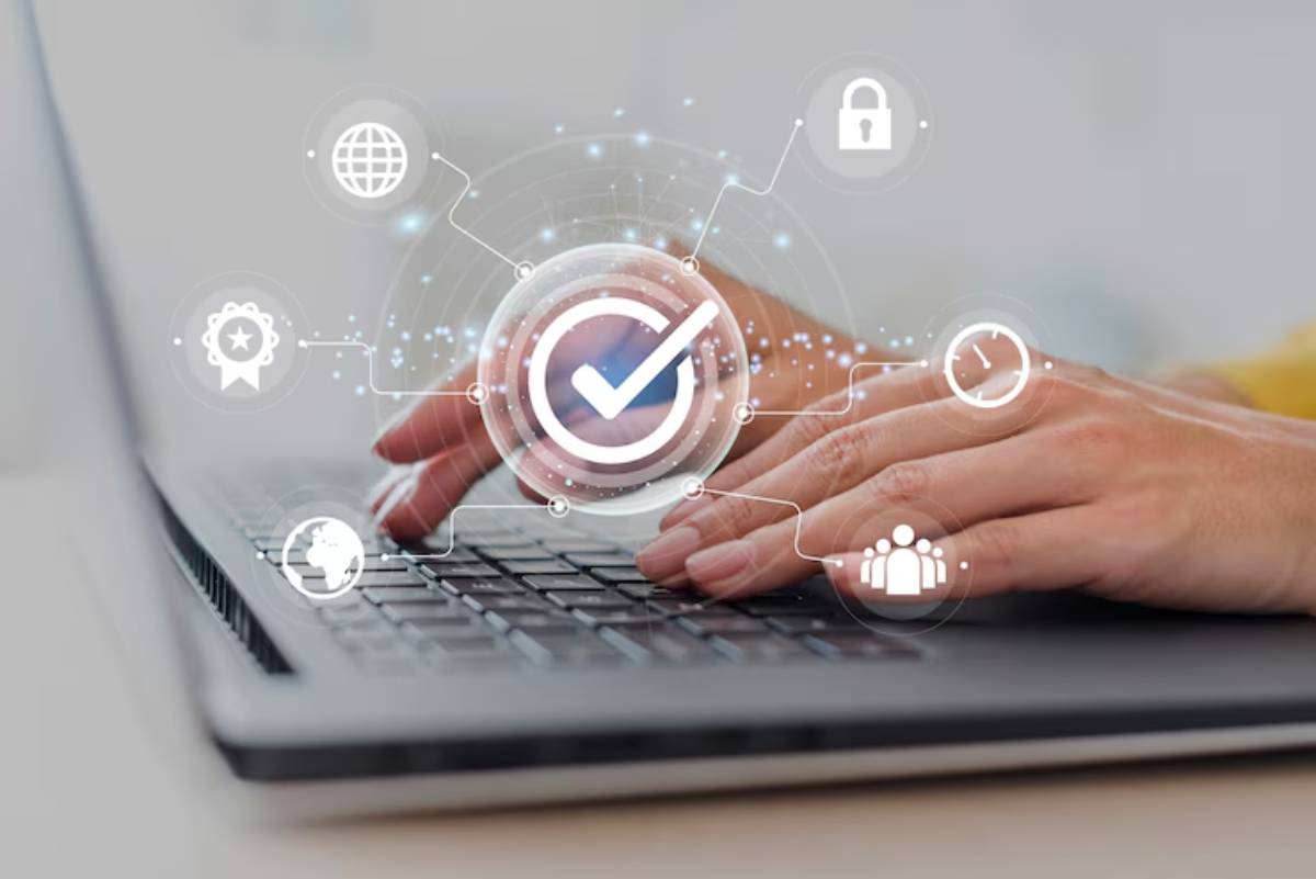 A person’s hands on a laptop keyboard, with digital icons representing security, connectivity, and time hovering above.